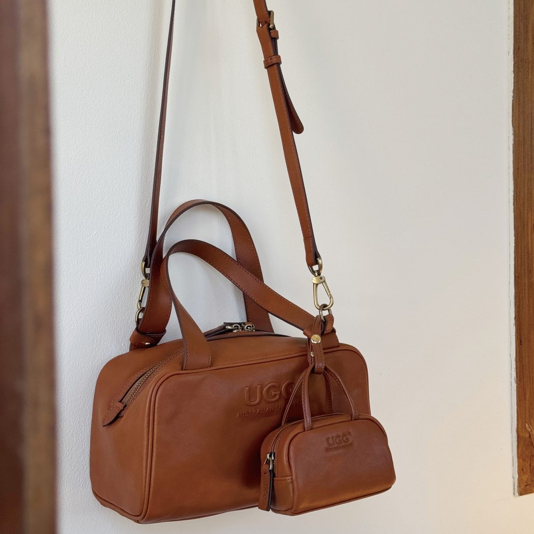 Angled view of AUSTRALIAN SHEPHERD® Dunelight Leather Barrel Crossbody Bag ASA 065 highlighting the detachable shoulder strap and compact design.