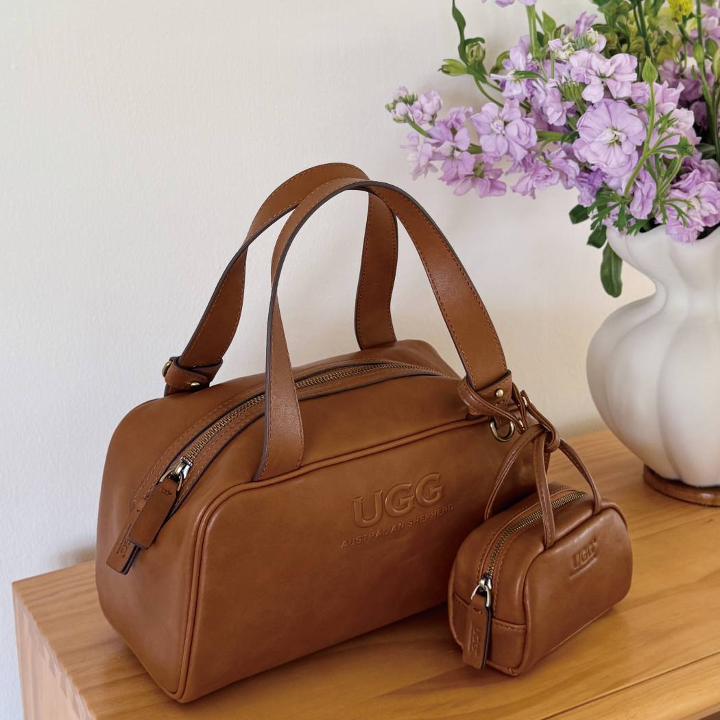 Lifestyle angle of AUSTRALIAN SHEPHERD® Dunelight Leather Barrel Crossbody Bag ASA 065 with matching leather accessory pouch.