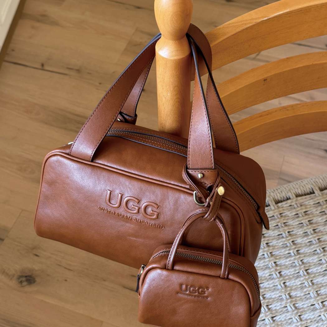 Close-up of the embossed logo on AUSTRALIAN SHEPHERD® Dunelight Leather Barrel Crossbody Bag ASA 065 crafted from genuine leather.