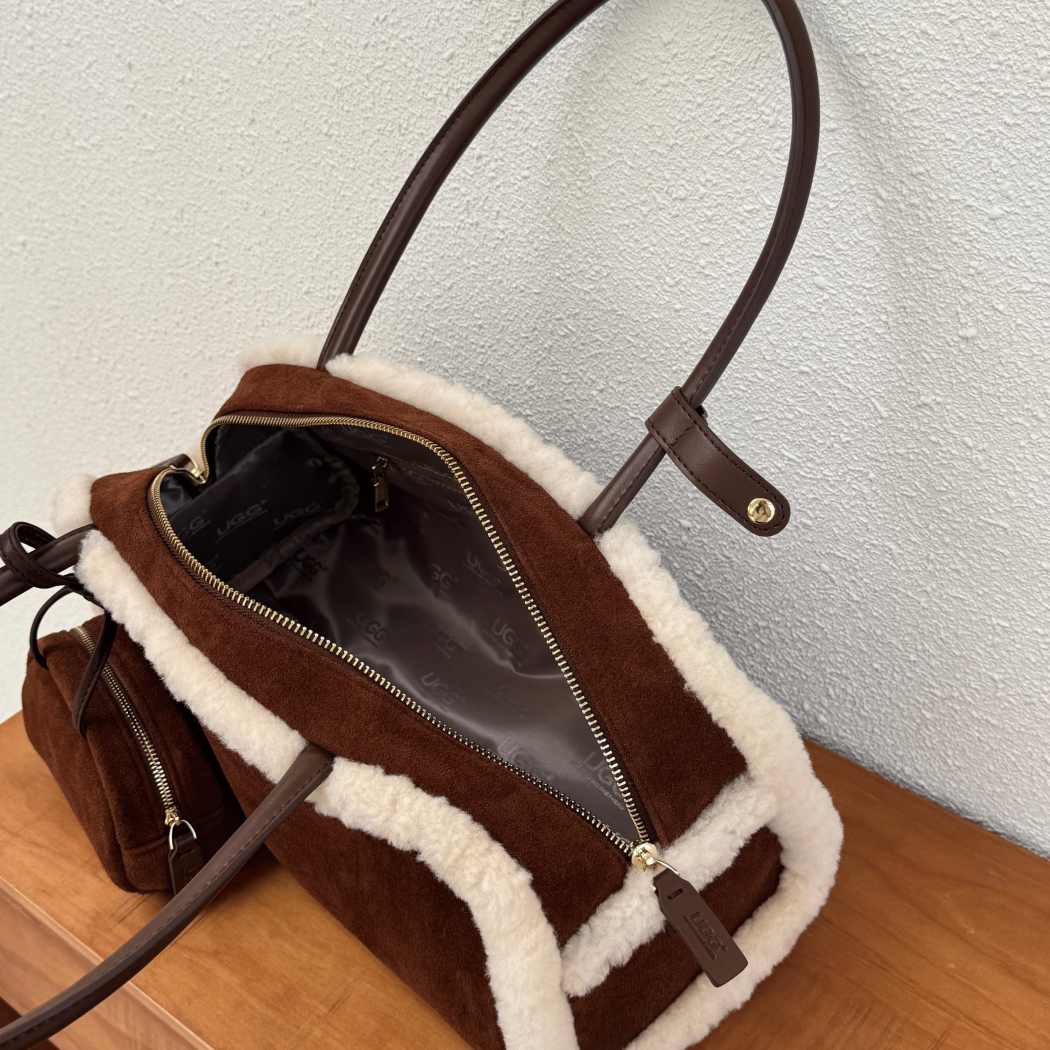 Side profile of AUSTRALIAN SHEPHERD® Snowbelle Wool & Leather Barrel Handbag ASA 064 highlighting the barrel silhouette and wool detailing.