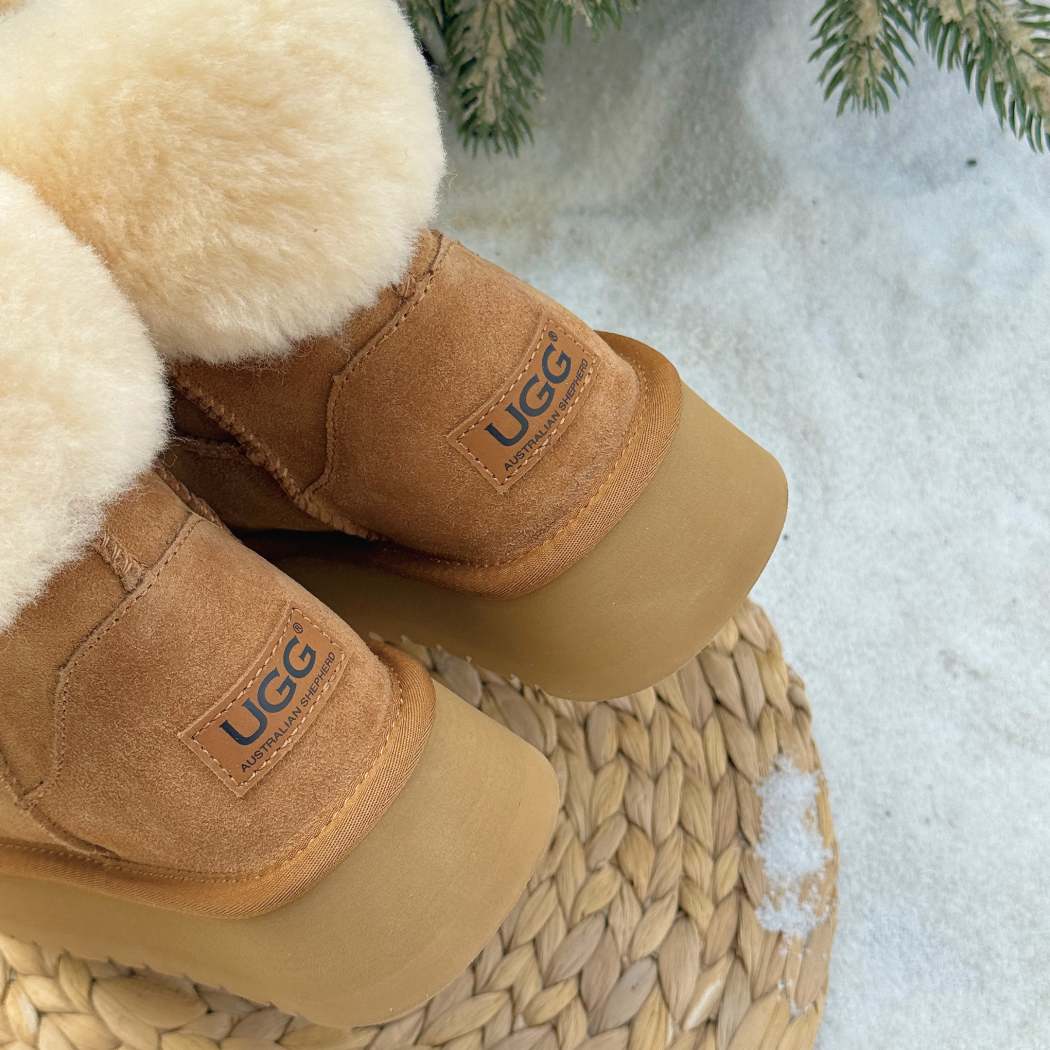 Angled front view of AUSTRALIAN SHEPHERD® UGG Boots Sheepskin Wool Mini Platform Eleny AS 3154 in Chestnut with premium suede and plush sheepskin wool trim.