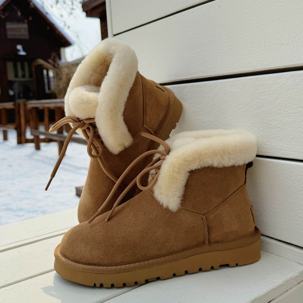 Angled view of AUSTRALIAN SHEPHERD® UGG Boots Women Sheepskin Wool Lace Up Dreva AS 3120 in Chestnut with fold-over sheepskin wool cuff.