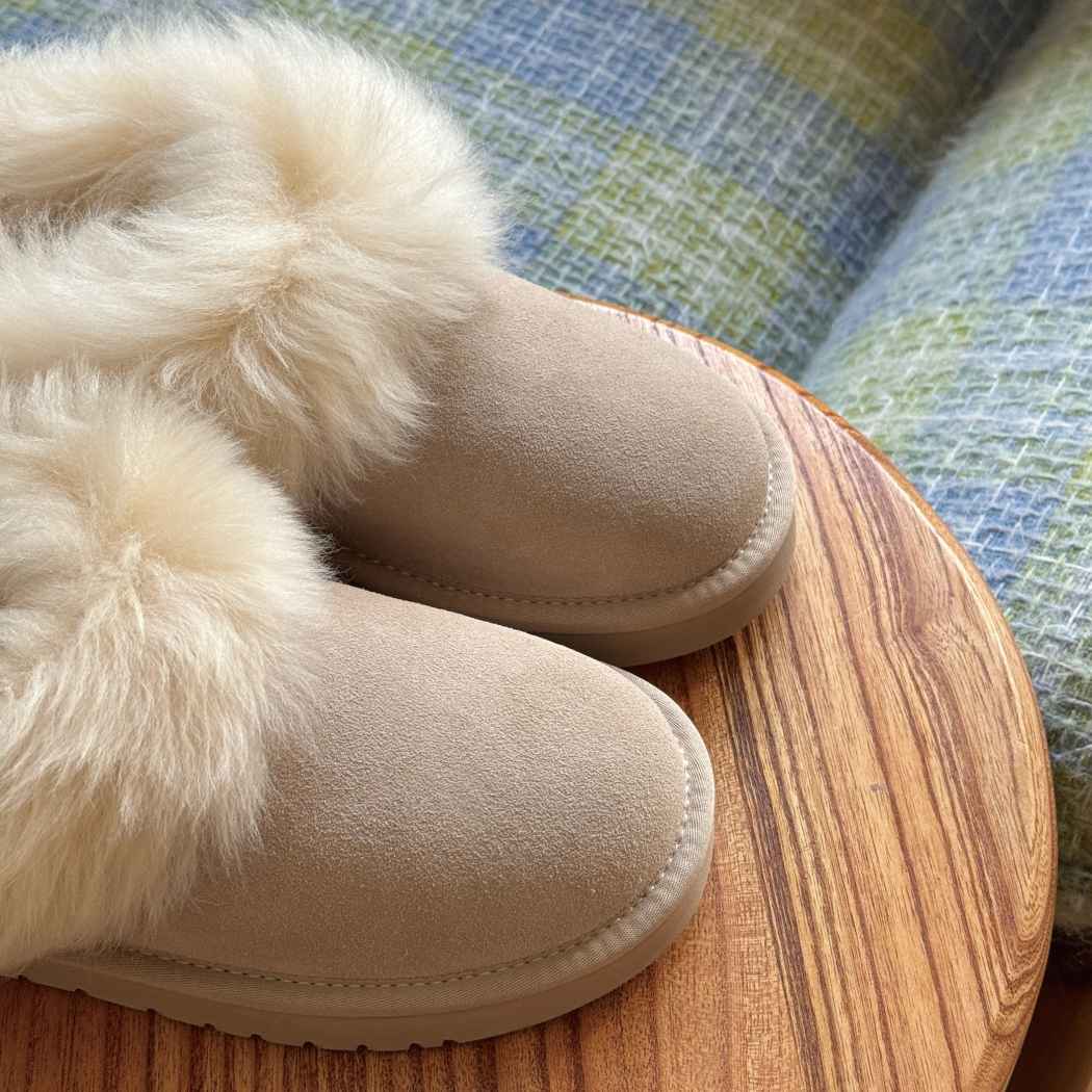 Side view of AUSTRALIAN SHEPHERD® UGG Slippers Sheepskin Wool Collar Ankle Mianee AS 2135 in Sand featuring a premium suede upper and plush wool trim.