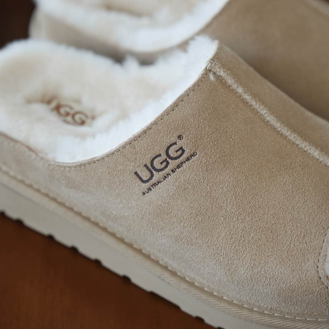 Logo detail of AUSTRALIAN SHEPHERD® UGG Slippers Sheepskin Wool Colven AS 7033 featuring premium cow suede with embossed UGG branding.