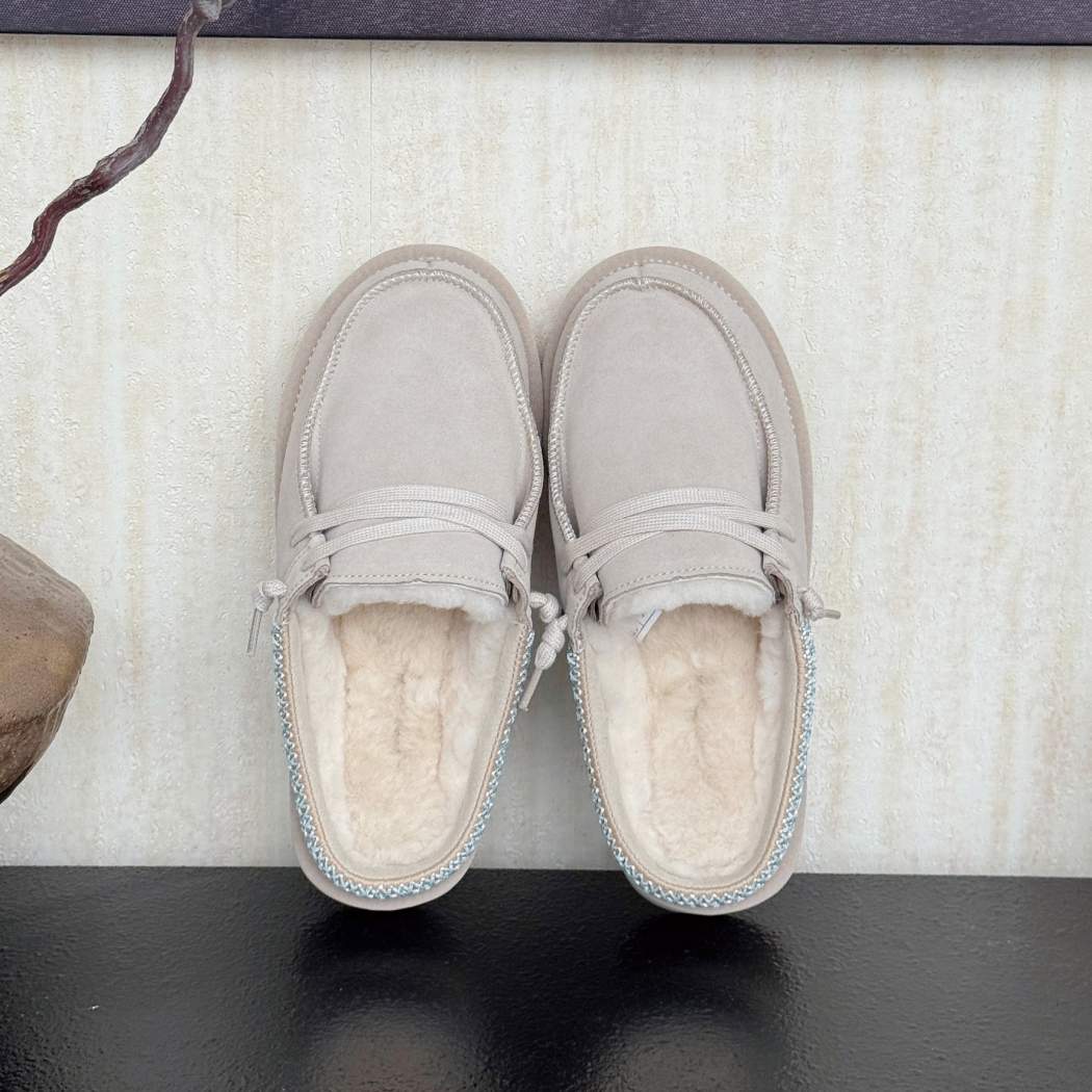 Side view of Australian Shepherd UGG women's platform mule slippers in Sand with premium suede upper, genuine Australian sheepskin wool lining, and a lightweight platform sole.