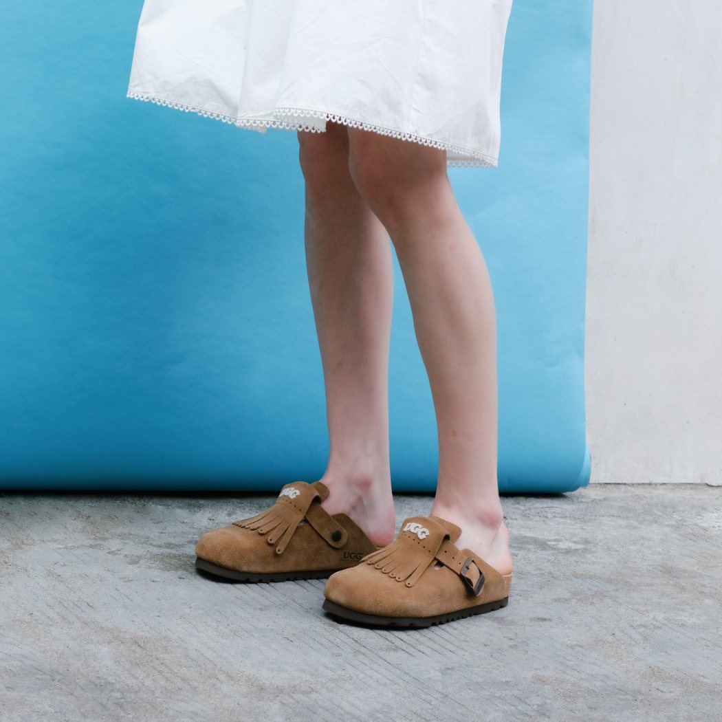 Side lifestyle view of Classic Birken cow suede clogs OZ 7001 in Taupe