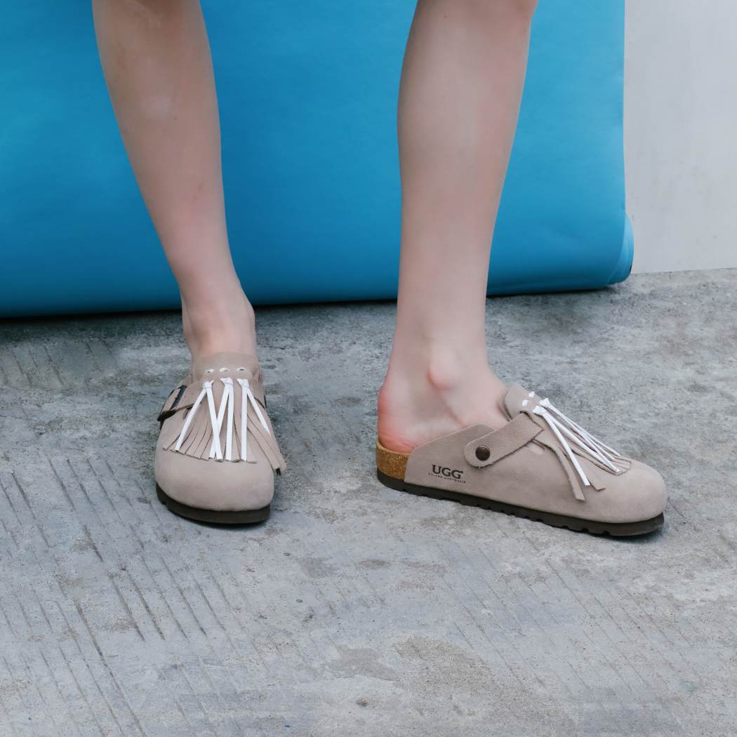 Lifestyle walking view of Classic Birken cow suede clogs OZ 7001 in Taupe