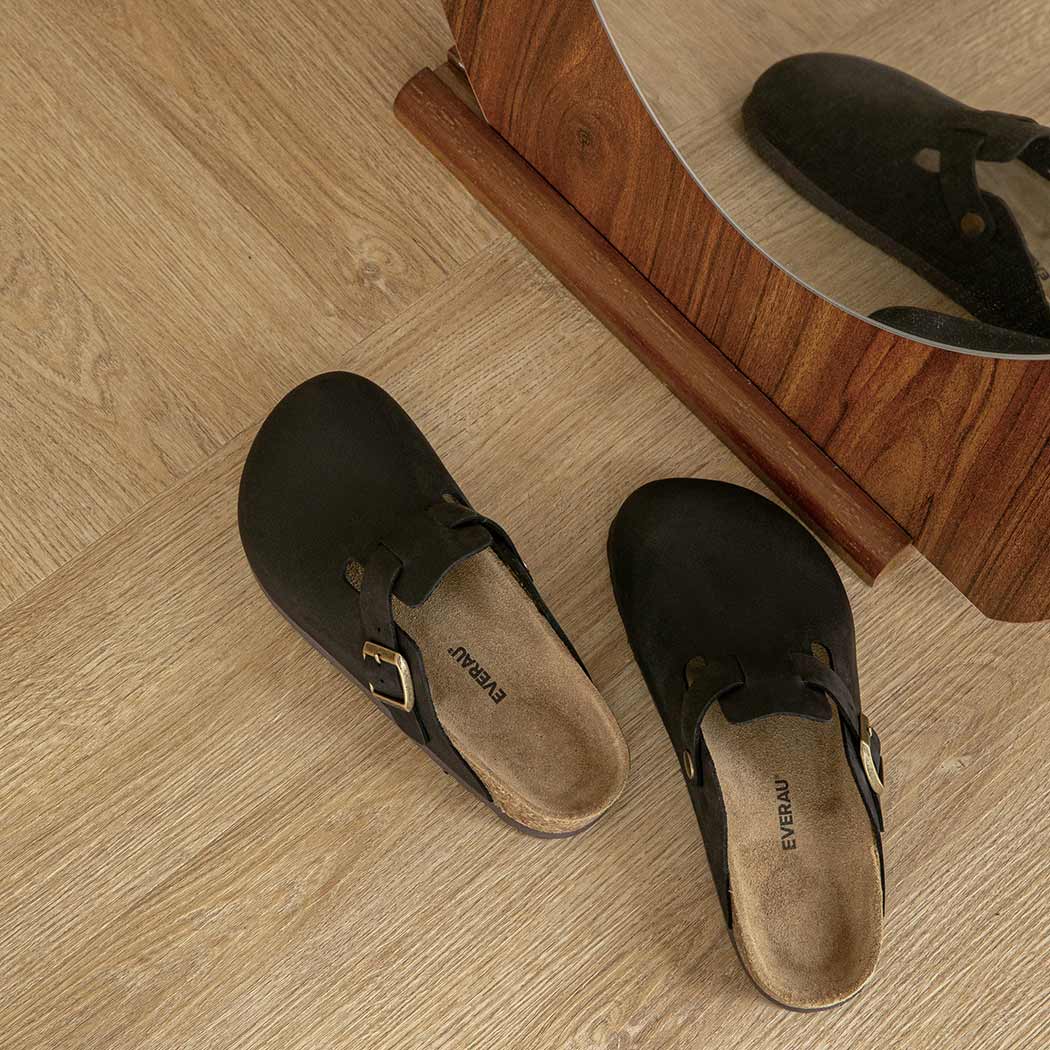 Pair of EVERAU Brooklyn Adjustable Buckled Slides Women Leather Slip-On Flat Sandals EA 7058 in Black with a classic slip-on silhouette.
