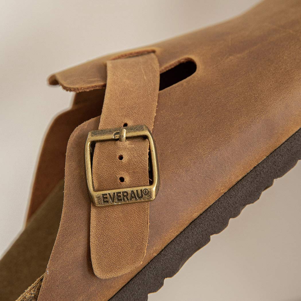 Close-up of the leather strap on EVERAU Brooklyn Adjustable Buckled Slides Women Leather Slip-On Flat Sandals EA 7058 with an adjustable buckle.