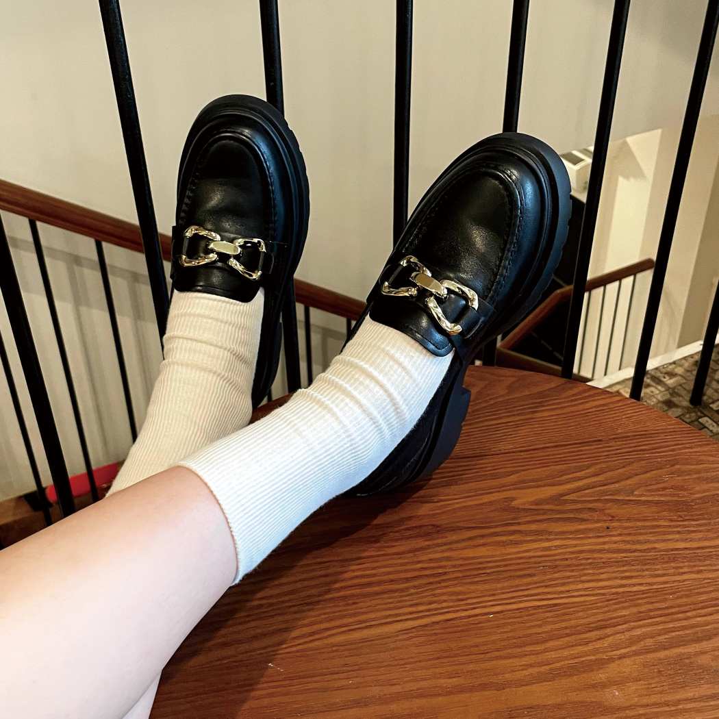 Lifestyle view of EVERAU® Women Leather Gold Buckle Platform Chunky Loafers Della EA 7032 in Black with a gold buckle and platform sole.
