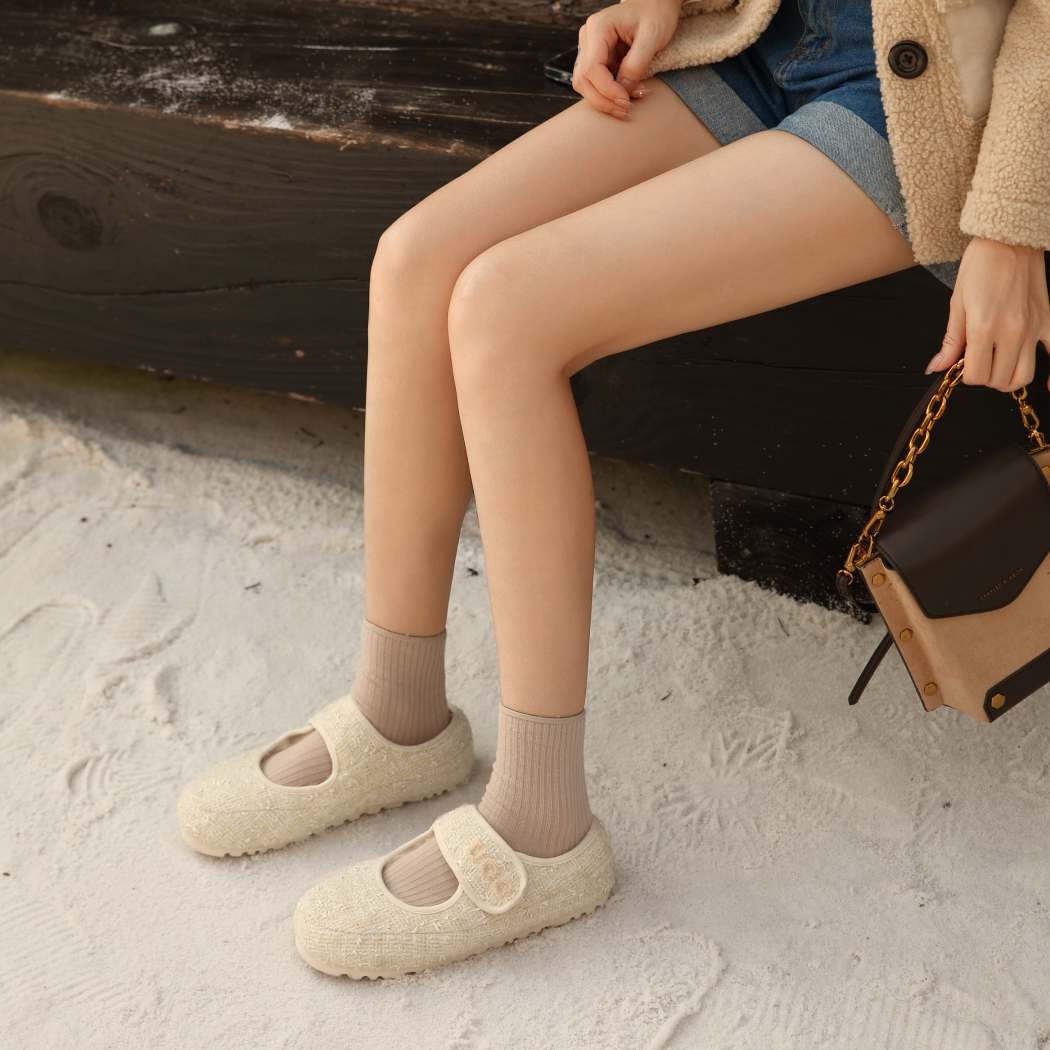 Woman wearing nude Tweed Mary Jane sheepskin wool moccasins DK 242